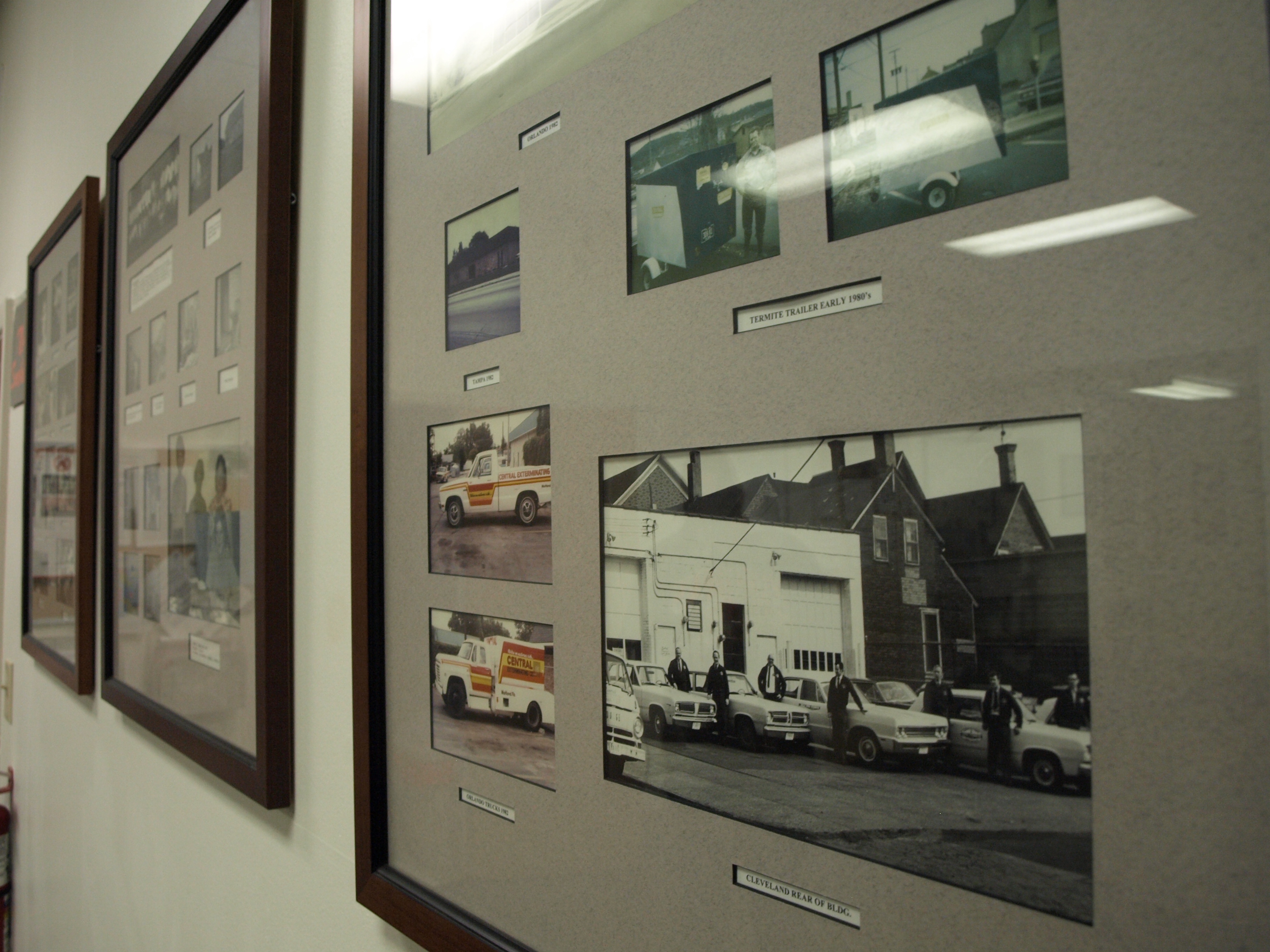 A photograph of a wall of pictures chronicalling the history of Central Exterminating Company.